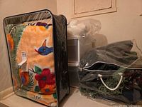 Fleece blanket in zip case, plastic bag of afghans, Sterilite drawers visible