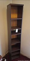 full front view of tall bookshelf with five shelves