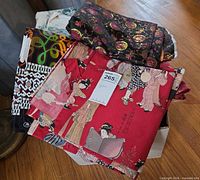 Box of assorted folded fabric pieces