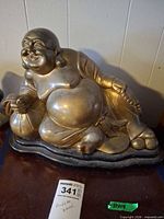 Front view of reclining Buddha coin bank