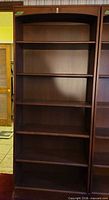Full frontal view of bookcase showing all shelves and overall condition