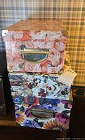 Stacked floral decorative storage boxes showing sizes, patterns and metal handles