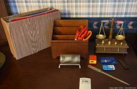 Group shot showing file box, desk organizer with scissors, spring letter holder, promo clock, letter opener