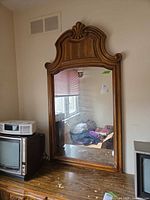 Full view of framed dresser mirror on dresser