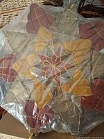 Full view of one capiz star parol covered in plastic wrap