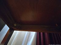 underside view of wooden chest legs and frame