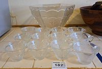 Punch bowl and twelve cups grouped on countertop