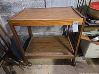 Full view of wood cart showing both shelves and casters