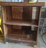 Full view front of microwave cart showing two shelves, laminate finish and casters