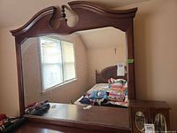 Front view showing full mirror and wood frame