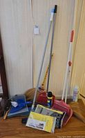 Group shot of all cleaning tools leaning against wall