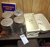 Planters and jars grouped on shelf