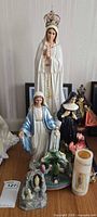 Group of statues, candle, grotto figurine and picture