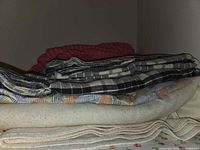 Stacked sheets and blankets in closet