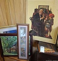 Group view of all five framed pieces leaning against wall