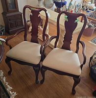 Two Thomasville upholstered captain's chairs front view