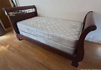 Side view of complete bed with mattress and box spring in frame