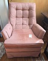 Front view of Fairfield pink upholstered swivel rocking chair showing tufted back, arms, seat, and skirted base