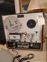 Front view of Akai GX-220 tape deck with reel and controls visible