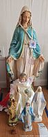 Group shot showing all statues including large Mary, Infant of Prague, others