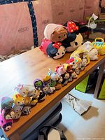 Overview showing jumbo plush, row of mini Tsum Tsums and carry bags