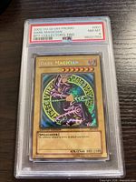 Front of PSA-slabbed Dark Magician card showing holographic card and PSA label
