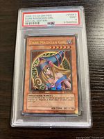 Front view of PSA-encapsulated 2005 Dark Magician Girl card showing grade and label