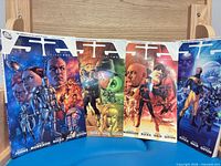 Front covers of 52 Volumes 1-4 displayed upright