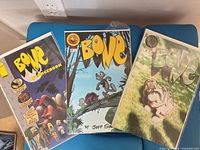 Three Bone comics including Sourcebook, mid-series forest cover, meadow cover