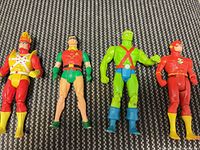 Front view of all four action figures standing upright