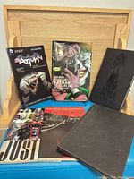 Front view showing five of the graphic novels upright and one lying flat