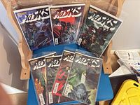 Group shot of all seven bagged Masks issues displayed on chair