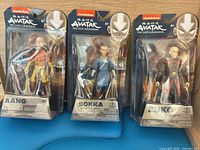 Front view of Aang, Sokka and Zuko blister-carded figures