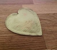 Top view of hammered brass heart dish showing overall form and texture