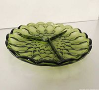 Oblique view showing scalloped edge, tri-divider, colour and overall condition