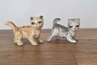Front view of both ceramic cat figurines