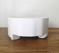 Side view showing plaster finish, leg design and overall height