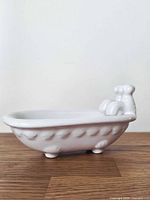 side profile showing tub shape, exterior texture and feet