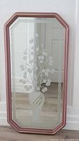 Front view of octagonal etched mirror with pink and gold frame