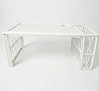 Full view of white wicker rattan bed tray, showing top surface and legs