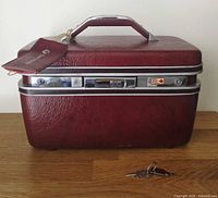 Front and top view of burgundy Samsonite train case showing keys and overall condition