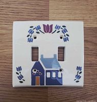 Front view of ceramic switch plate with cottage and tulip design