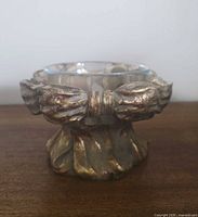 Front view of chalkware stand with glass bowl inserted