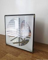 Front view of square glass and brass display box