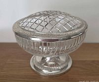 Oblique view showing full bowl, ribbed glass body, silver-plated rim and lattice lid