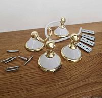 All four ceramic accessories with mounting hardware laid on wooden surface