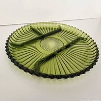 Top view of green glass divided relish plate showing four compartments and ribbed design