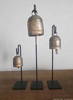 Front view of all three iron bell stands