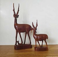 Both teak antelope figurines front view