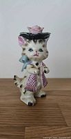 Front three-quarter view of ceramic Miss Kitty cat figurine showing outfit and facial details